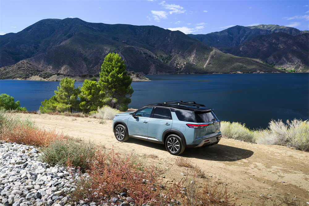 2026 Nissan Pathfinder driving on an open road, highlighting its powertrain and performance capability